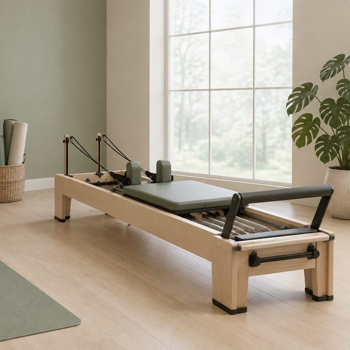 A reformer machine in a bright studio with a tall window